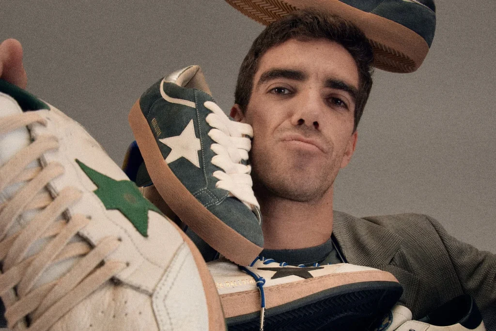 Male model surrounded by colorful low-top sneakers