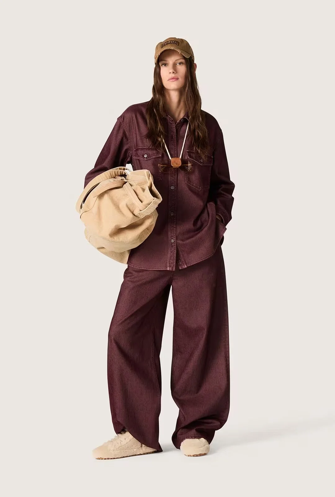 Woman wearing a burgundy casual outfit and sneakers