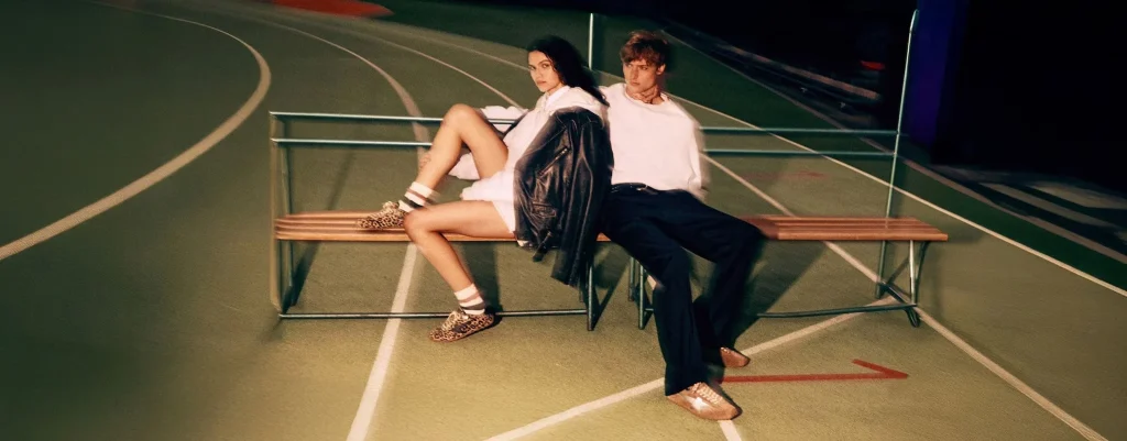 Woman in a white suit styled with white low-top sneakers